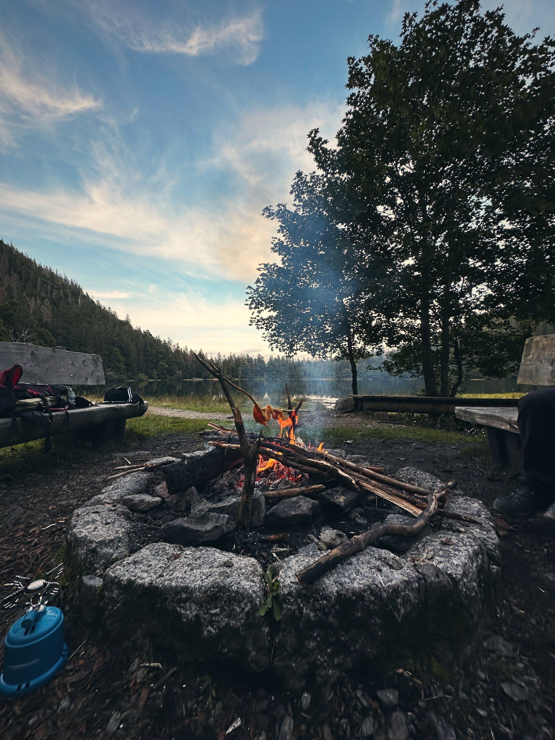 Feuer in einer steinernen Feuerstelle am See