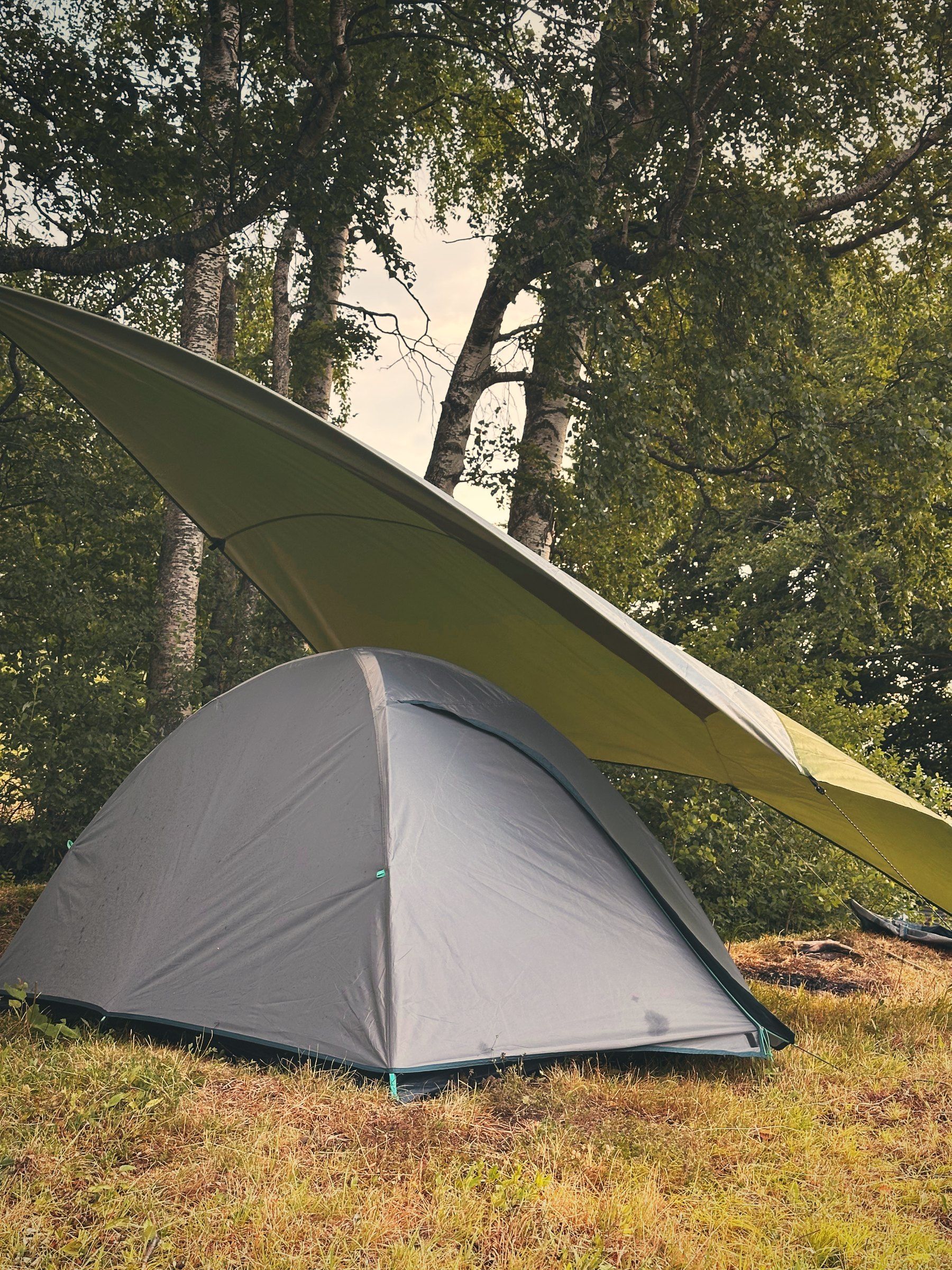 Tent under a tarp above Lake Uri